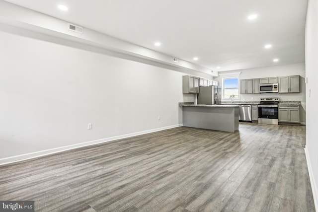 unfurnished living room with dark hardwood / wood-style flooring and sink