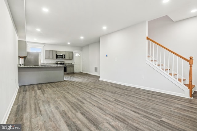 unfurnished living room featuring dark hardwood / wood-style flooring