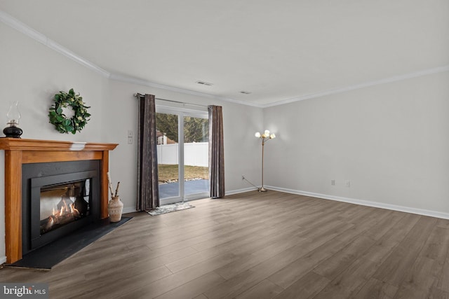 unfurnished living room featuring ornamental molding, a glass covered fireplace, wood finished floors, and visible vents