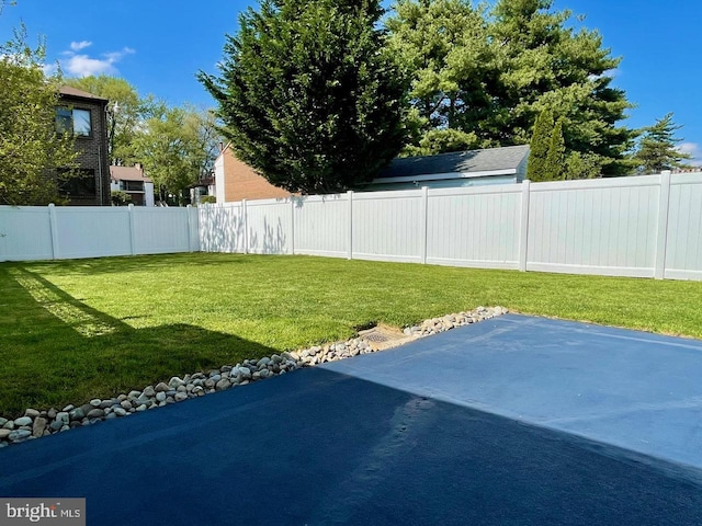 view of yard with a fenced backyard and a patio