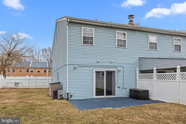 rear view of property with a patio area, a lawn, central AC, and fence