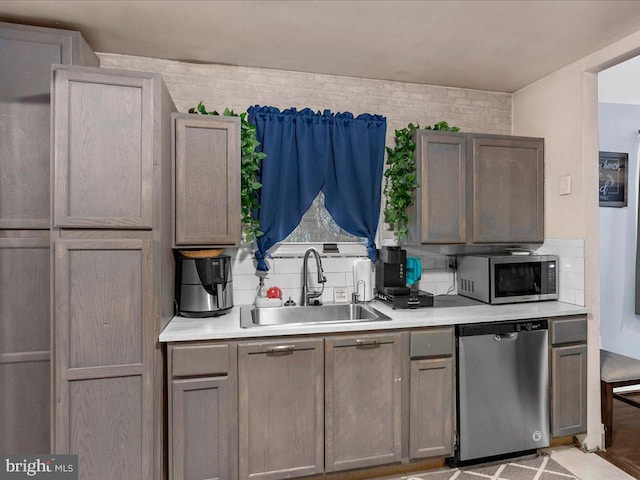 kitchen featuring backsplash, sink, and stainless steel appliances