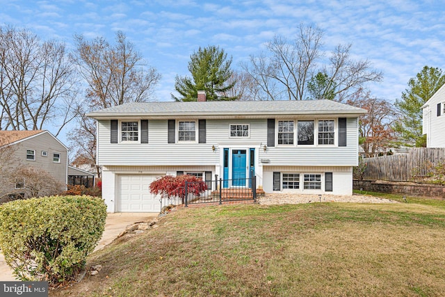 raised ranch with a front yard and a garage