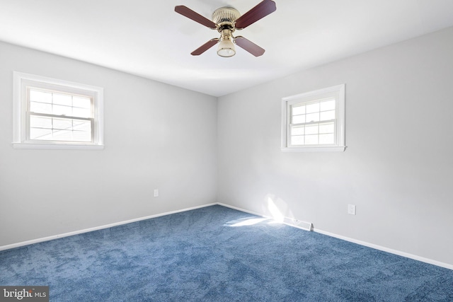 spare room featuring ceiling fan, plenty of natural light, and carpet