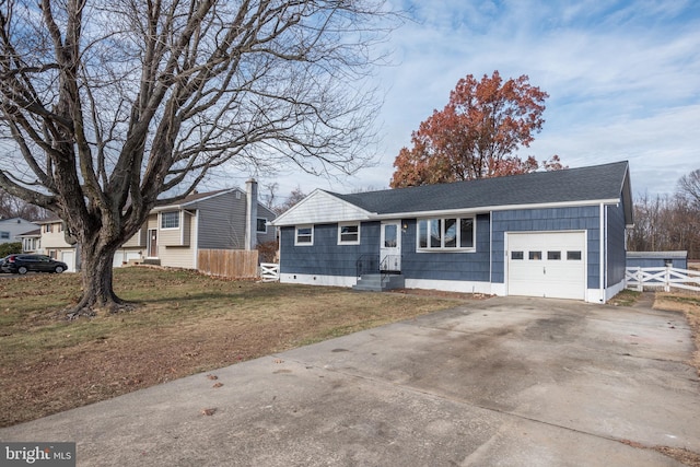 single story home with a front yard and a garage