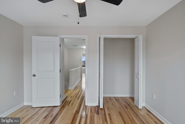 unfurnished bedroom with ceiling fan and light hardwood / wood-style floors