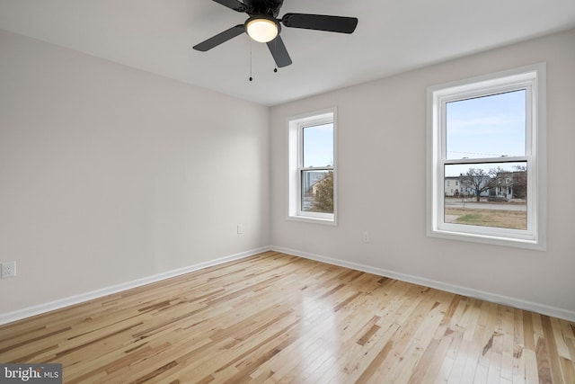 empty room featuring light wood-type flooring and ceiling fan