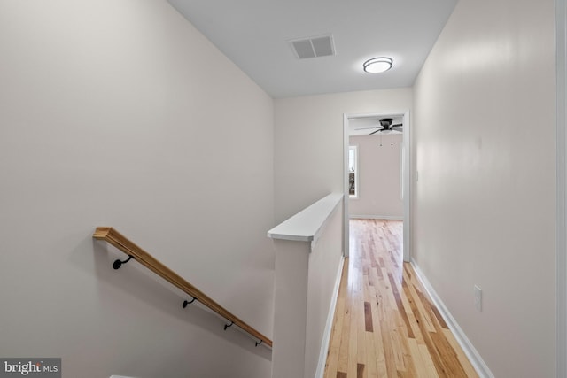 corridor with light hardwood / wood-style floors