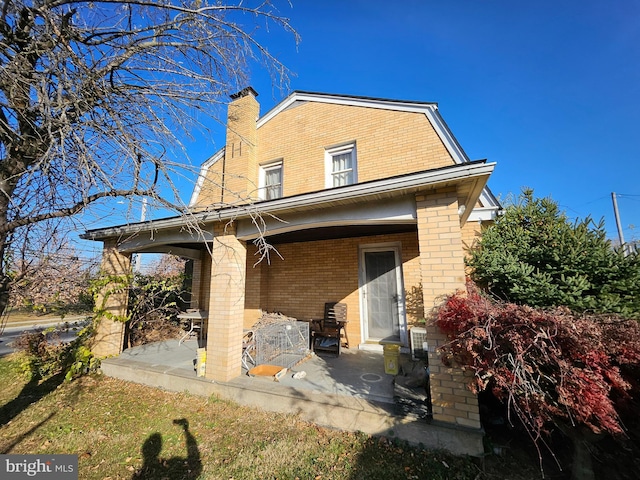 back of property with a patio