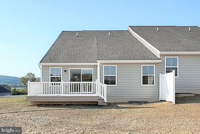 rear view of property with a wooden deck