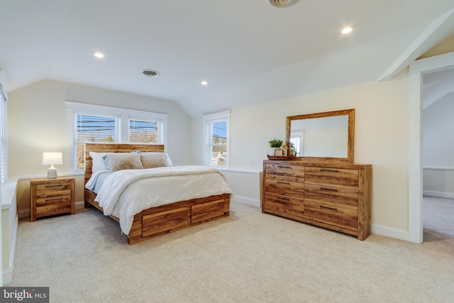 carpeted bedroom with lofted ceiling