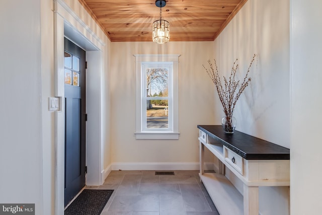 doorway to outside with a chandelier and wooden ceiling