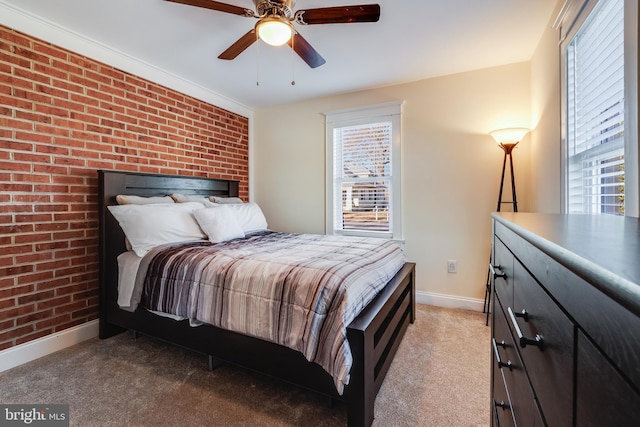 bedroom with light carpet, ceiling fan, and brick wall