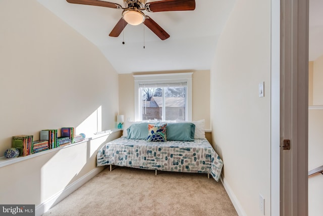 carpeted bedroom with ceiling fan and vaulted ceiling