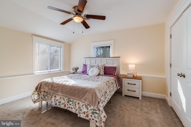 carpeted bedroom with ceiling fan and vaulted ceiling