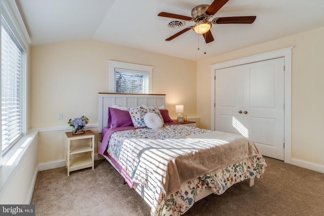 carpeted bedroom featuring multiple windows, ceiling fan, and lofted ceiling