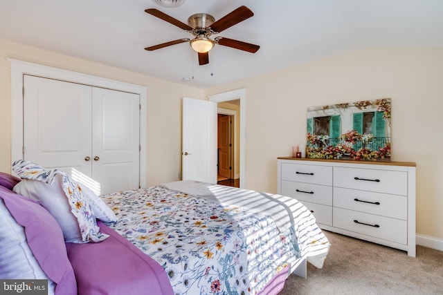 bedroom featuring a closet, ceiling fan, and light colored carpet