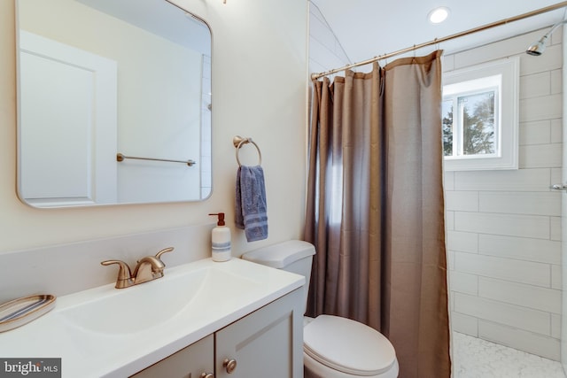 bathroom featuring vanity, toilet, and curtained shower