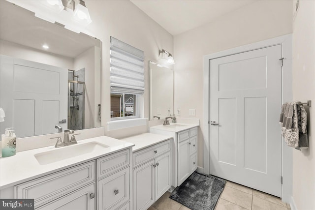 bathroom with tile patterned flooring, vanity, and a shower