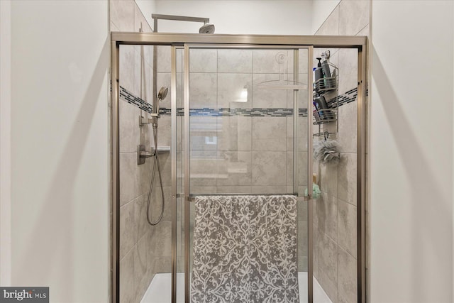 bathroom featuring a shower with door