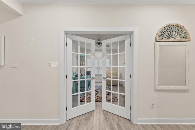 doorway with french doors, light hardwood / wood-style floors, and ceiling fan