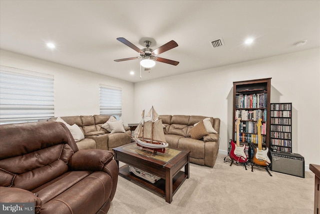 carpeted living room with ceiling fan