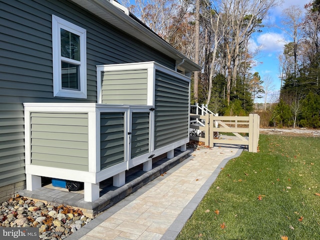 view of side of home with a yard