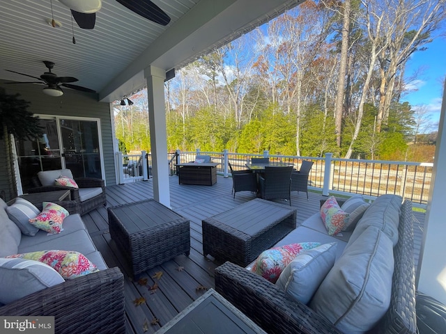 wooden terrace with ceiling fan and an outdoor hangout area