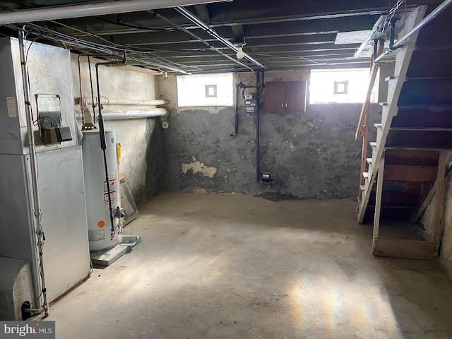 basement featuring a healthy amount of sunlight and gas water heater