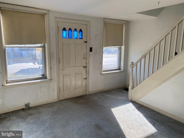 view of carpeted foyer entrance