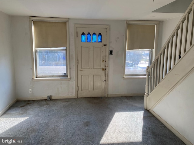 view of carpeted foyer entrance