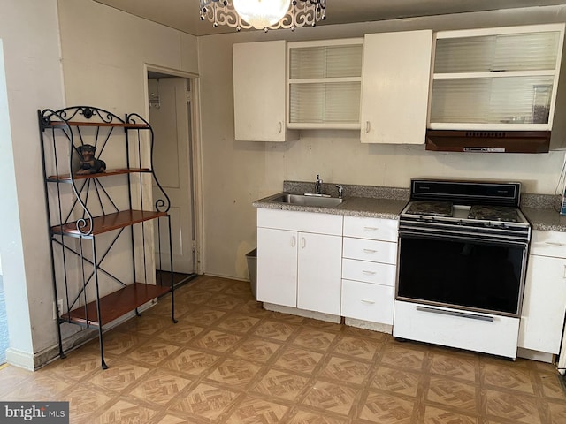 kitchen with white cabinetry, sink, extractor fan, light parquet flooring, and range