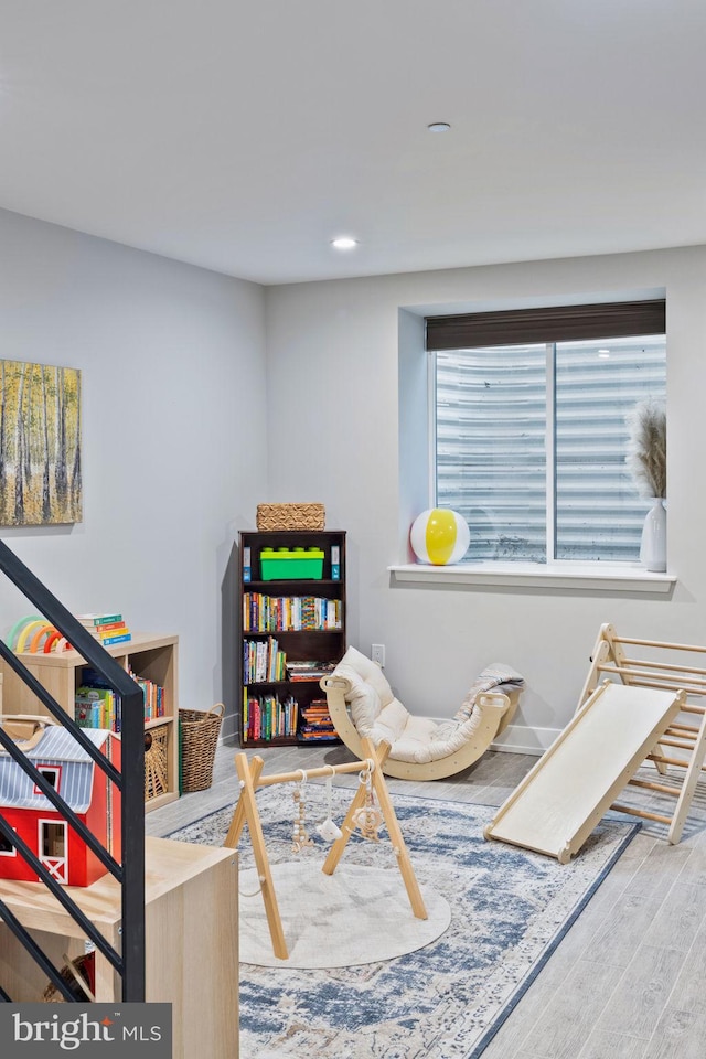 recreation room with wood-type flooring