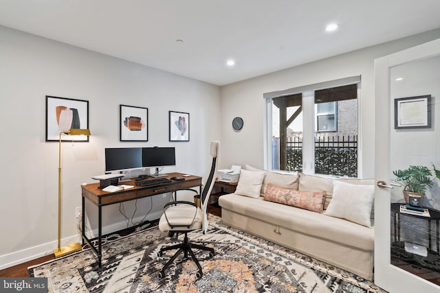 home office with hardwood / wood-style flooring