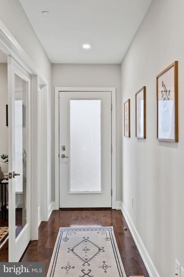 doorway to outside featuring french doors and dark wood-type flooring