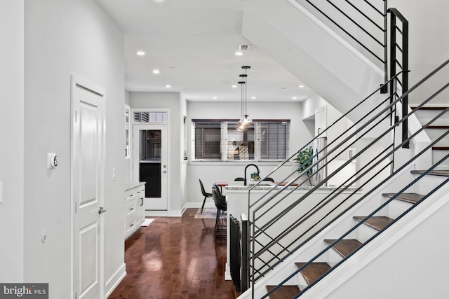 stairway with hardwood / wood-style floors