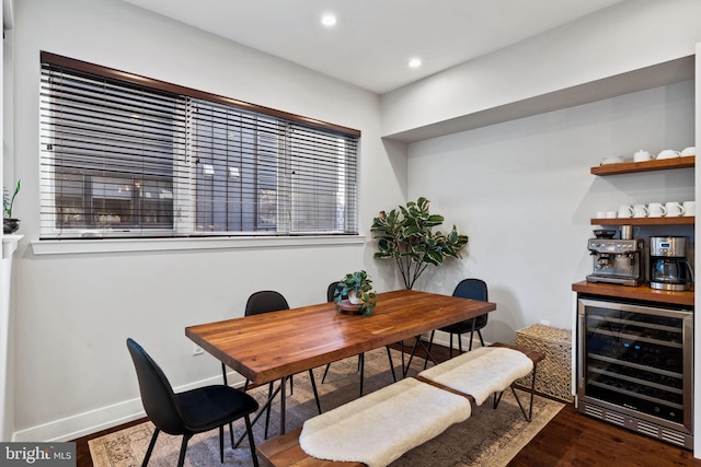 dining room with dark hardwood / wood-style floors and wine cooler