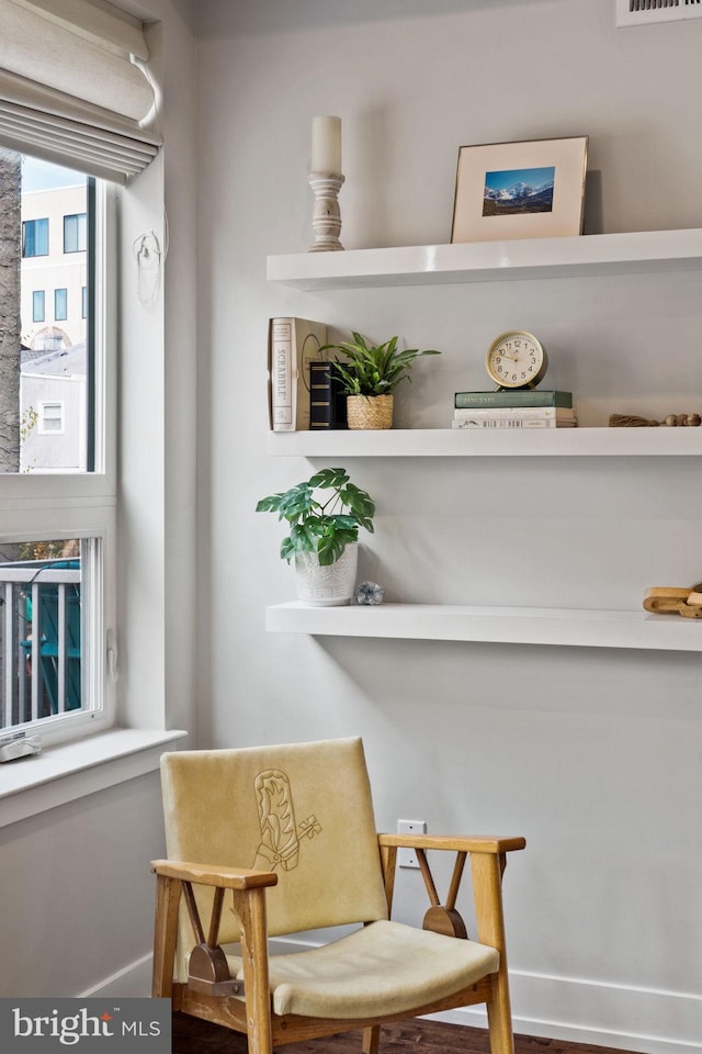 sitting room with wood-type flooring