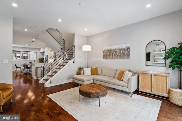 living room with sink and dark wood-type flooring