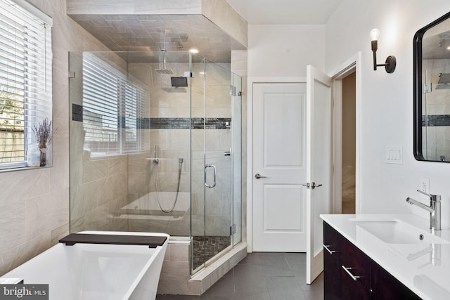 bathroom with tile patterned flooring, vanity, and independent shower and bath