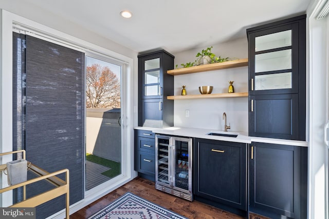 bar with wine cooler, dark hardwood / wood-style flooring, and sink