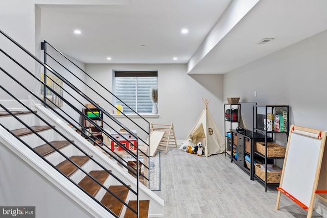 stairway with hardwood / wood-style flooring