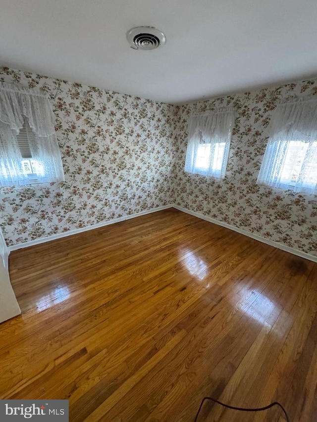 unfurnished room with hardwood / wood-style floors