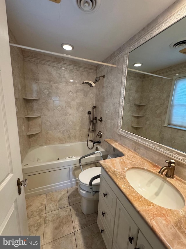 full bathroom with vanity, toilet, tile patterned flooring, and tiled shower / bath