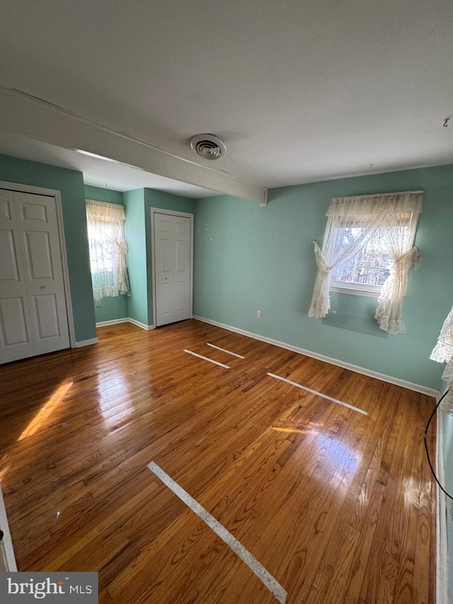 unfurnished bedroom featuring hardwood / wood-style floors