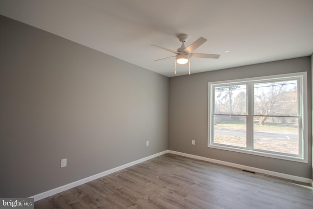 empty room featuring ceiling fan and light hardwood / wood-style flooring