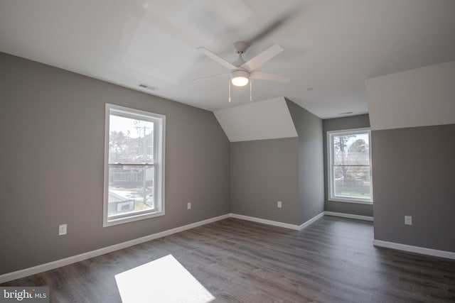 bonus room featuring vaulted ceiling, a wealth of natural light, and dark wood-type flooring