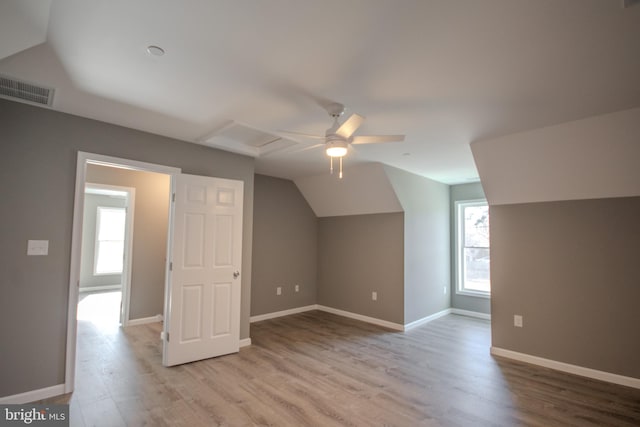 bonus room with light hardwood / wood-style floors, vaulted ceiling, and ceiling fan