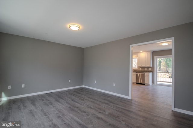 unfurnished room with hardwood / wood-style floors