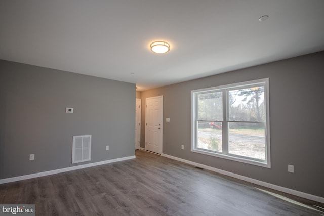 empty room with hardwood / wood-style floors